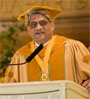 Dr Ramani Ayer in cap and gown at the podium