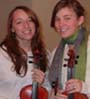Two young violinists with their instruments