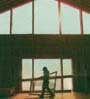 builder carrying window in building under construction